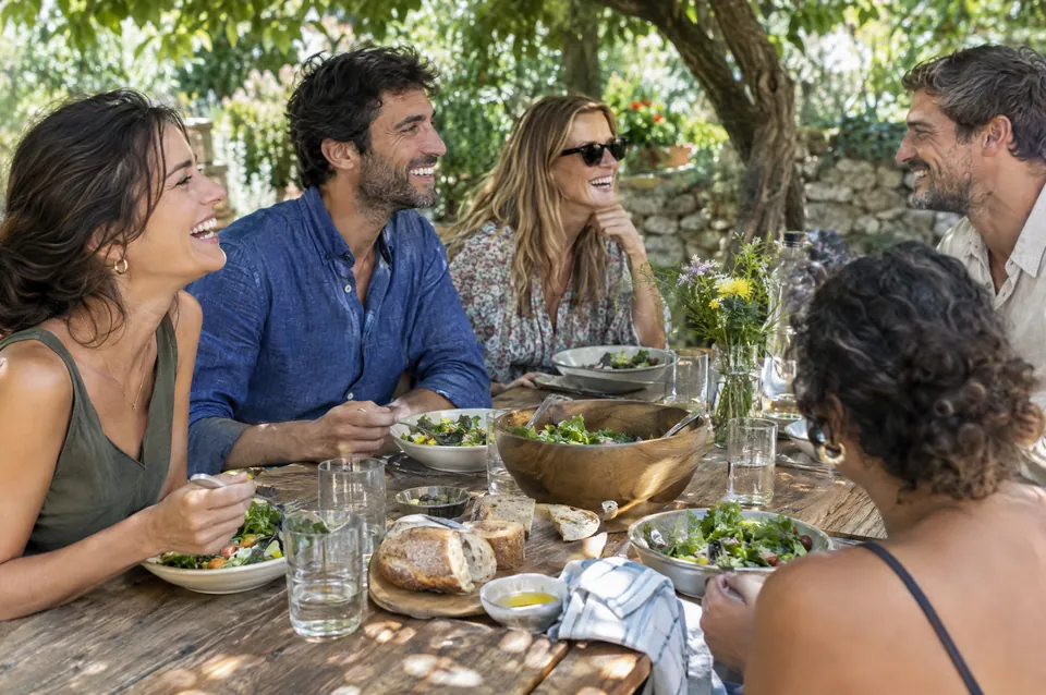Friends sharing a relaxed meal outdoors